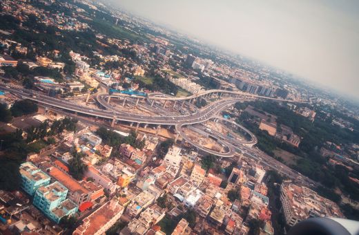 Aerial photo covering a flyover bridge, houses and tall buildings in Chennai
